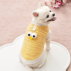 Detail view of yellow fleece dog vest with cartoon eyes and metal D-ring for leash