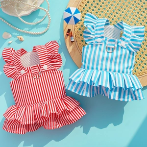 Close-up of striped pet dresses with D-ring leash attachment and ruffled summer details