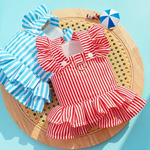 Detail of striped pet dress with double ruffles, metal D-ring and summer props