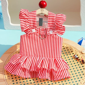 Detail of red striped pet dress featuring double ruffled hem and metal D-ring for leash