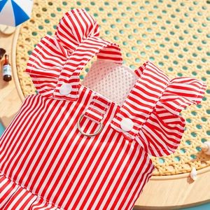 Detail of red striped dog dress featuring a metal D-ring and ruffled summer beach design