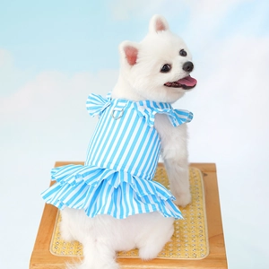 Detail of blue striped pet dress with ruffled edges and a metal D-ring for leash attachment