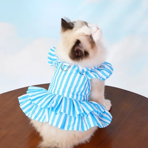 Close-up of blue striped pet dress with ruffle hem and metal D-ring for leash attachment