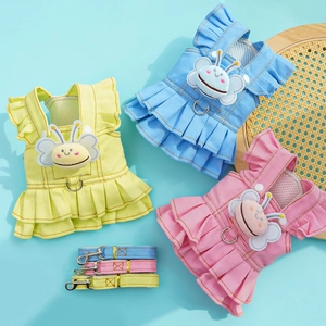 Detailed view of denim pet dresses with plush butterfly patches and matching leashes