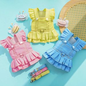 Three-piece denim pet dress set with ruffles and leash attachment on blue background