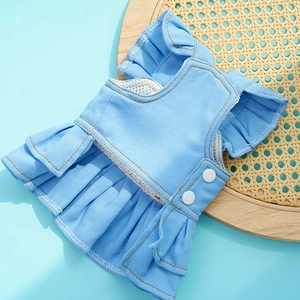Detail of light blue denim pet dress with white breathable mesh lining and snap buttons