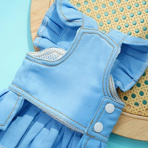 Detail view of denim pet dress showing ruffled edges and breathable mesh lining