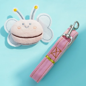 Close-up of pink denim pet leash with plush butterfly pendant and silver metal hook