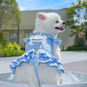 Detail of light blue denim pet dress featuring plush bee patch and metal D-ring attachment