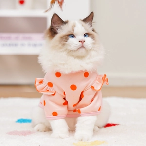 Detailed view of pink polka dot pet shirt with ruffle sleeves on a cat model
