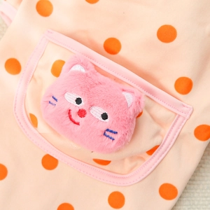 Macro detail of pink polka dot pet shirt featuring a cute plush cat head decoration