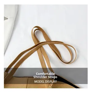 Close-up of the comfortable wide shoulder strap on a brown faux suede tote bag