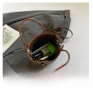Interior view showing the large capacity of the brown pebble leather bucket bag