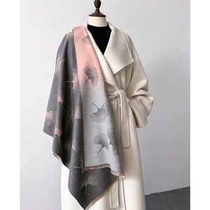 Close-up of pink and grey gradient leaf print shawl over an elegant white coat