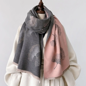 Detail of reversible pink and gray shawl featuring a nature-inspired gingko leaf pattern