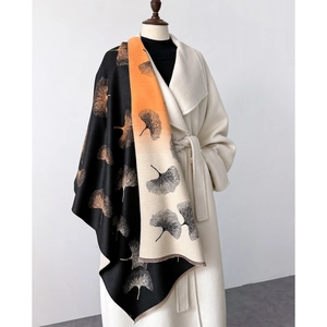 Close-up of tricolor scarf with gingko leaf print and delicate short fringe detail