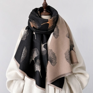 Detail of elegant ginkgo leaf print on soft black and beige cashmere feel shawl