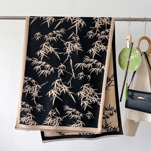 Detailed view of bamboo leaf pattern scarf with frayed edges and oriental texture