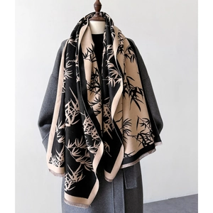 Close-up of vintage bamboo leaf print scarf with elegant fringe detail on soft fabric