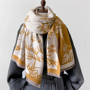 Detail of bamboo leaf jacquard scarf in mustard yellow and beige with fringe trim