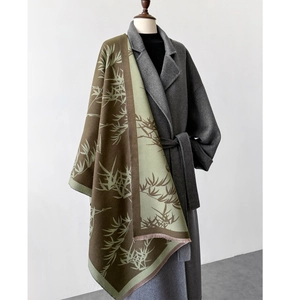 Detail of bamboo leaf pattern on vintage rectangle scarf draped over a grey wool coat
