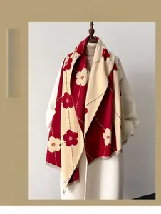 Close-up of red and beige floral cashmere scarf with delicate short fringe edges