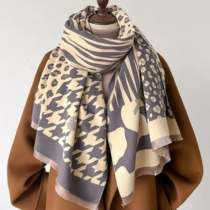 Detail of cashmere-like scarf with leopard, zebra and houndstooth patterns and fringes