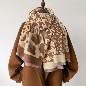 Plaid and leopard print patchwork winter shawl with tassels on a wool coat
