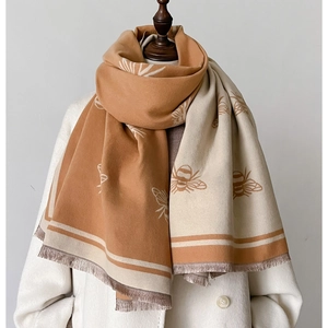 Winter faux cashmere scarf with bee print and fringe on a caramel and cream dual-sided shawl