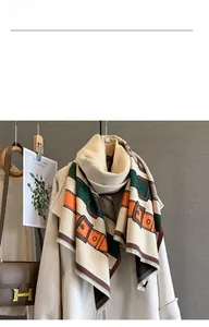 Close-up of thick jacquard scarf with leather belt pattern and fringe details