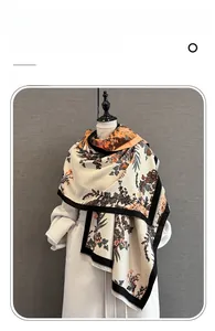 Detailed texture of imitation cashmere scarf with floral patterns and fringe edges