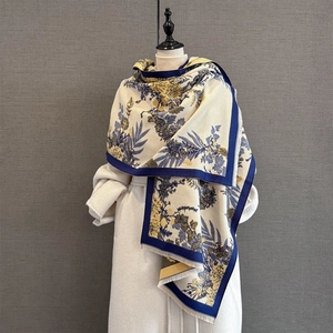 Close-up of floral pashmina shawl with blue botanical prints and tassel details
