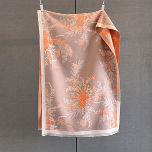 Detail of vintage floral pashmina scarf with orange lilies and purple knit texture