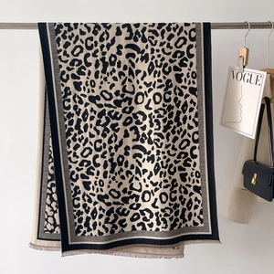 Detail of leopard print scarf with fringe edges and premium cashmere texture