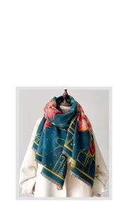 Detail of dark teal cashmere-like scarf with red lotus print and tassel edges