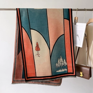 Close-up of geometric landscape print shawl with contrast colors and fringe trim detail
