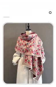 Detailed texture of imitation cashmere scarf featuring red rose floral prints and tassels