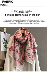 Detail of soft beige scarf with red rose pattern and elegant tassels for winter