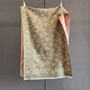 Detail of rose floral jacquard scarf with green and pink sides and white fringe