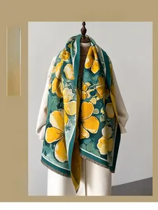 Detail of yellow floral pattern on dark green scarf with soft fringe edges and thick texture