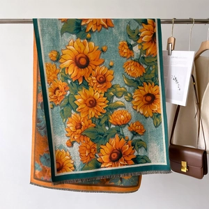 Elegant yellow sunflower print cashmere scarf with fringe edges and vibrant blue base