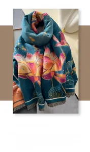 Detailed macro view of the soft thick cashmere-like scarf with orange lotus patterns