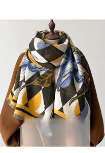 Close-up of diamond pattern and floral print scarf with tassel edge on a mannequin