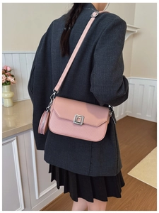 Detail of pink small square crossbody bag with textured leather and round coin purse