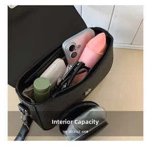 Interior view of black crocodile pattern bag showing spacious capacity for phone and cosmetics