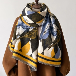 Diamond pattern floral cashmere feel scarf with fringe on a brown wool coat