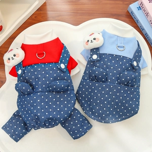 Close-up of polka dot denim pet overalls with metallic D-ring and plush bear charm