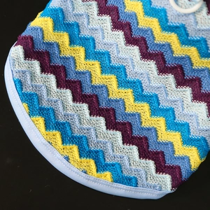 Close-up of zigzag knitted pet clothing fabric with colorful wave patterns and neat stitching