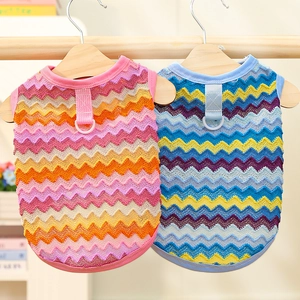 Detail of knitted pet vests in pink and blue with metal leash rings and wave texture