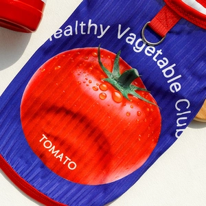 Detail of ribbed knit pet vest featuring tomato print and a metal D-ring for leash attachment